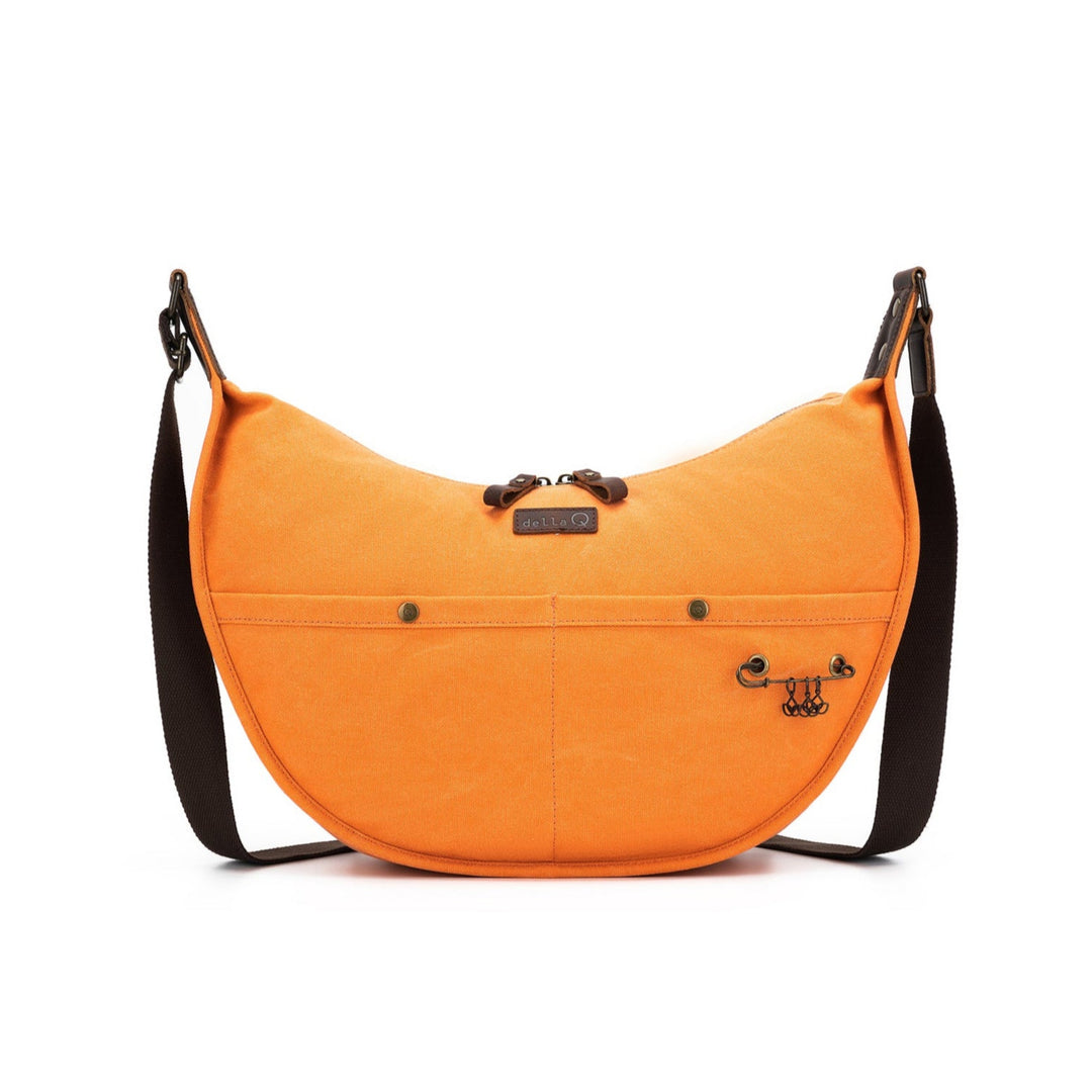 Orange crossbody bag with a black strap on a white background