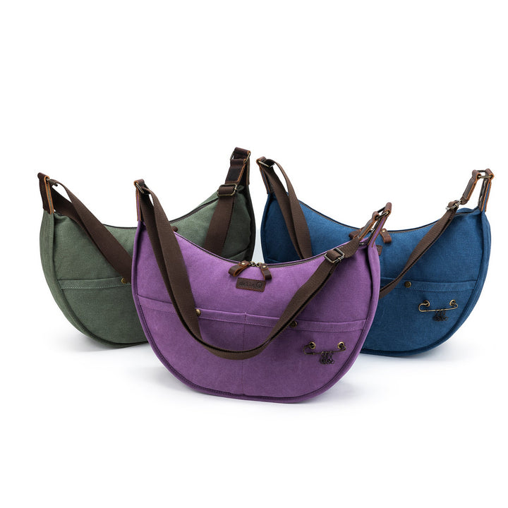 Three bags in green, purple, and blue with brown straps on a white background
