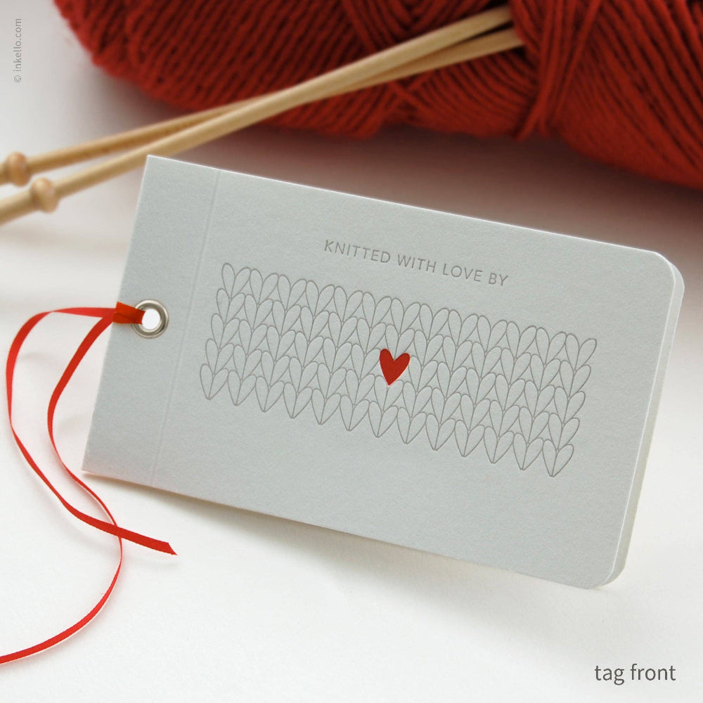Knitted with Love tag with red heart and yarn ball on a light background