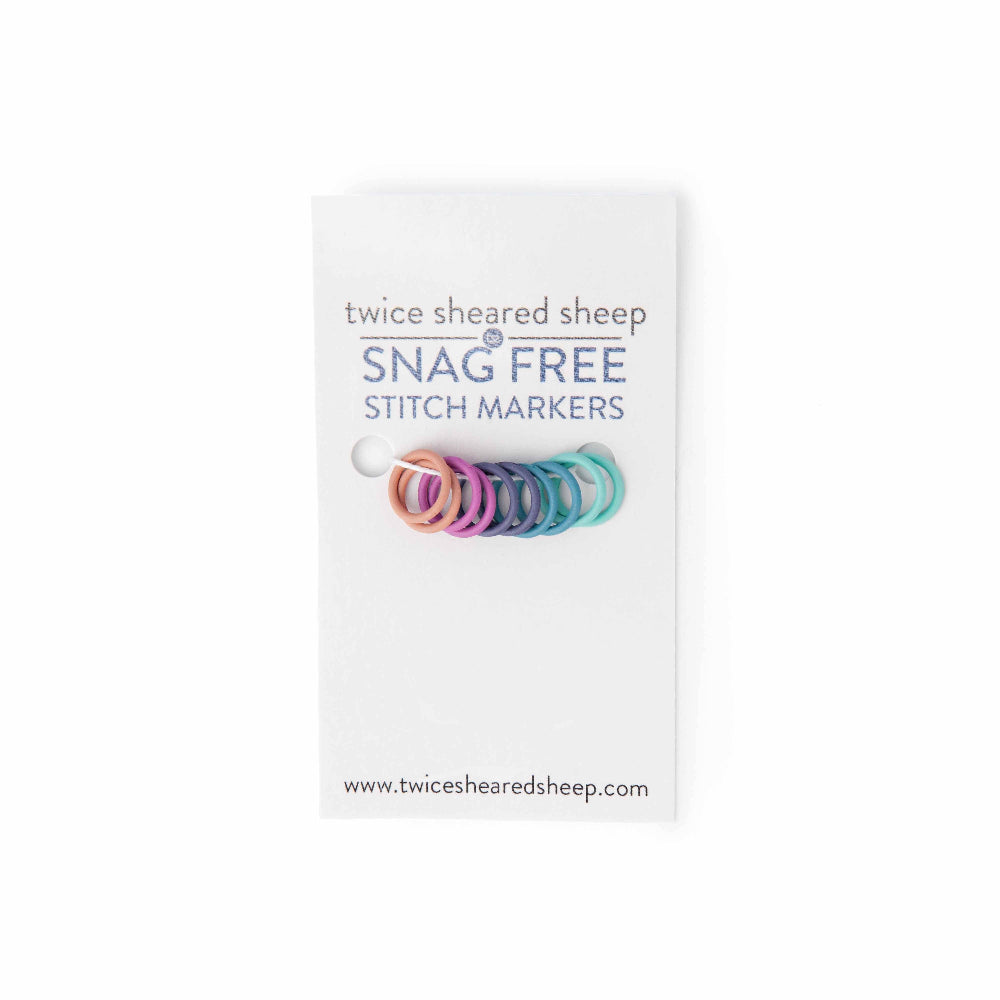 Packaging of snag free stitch markers with colorful markers on a white background