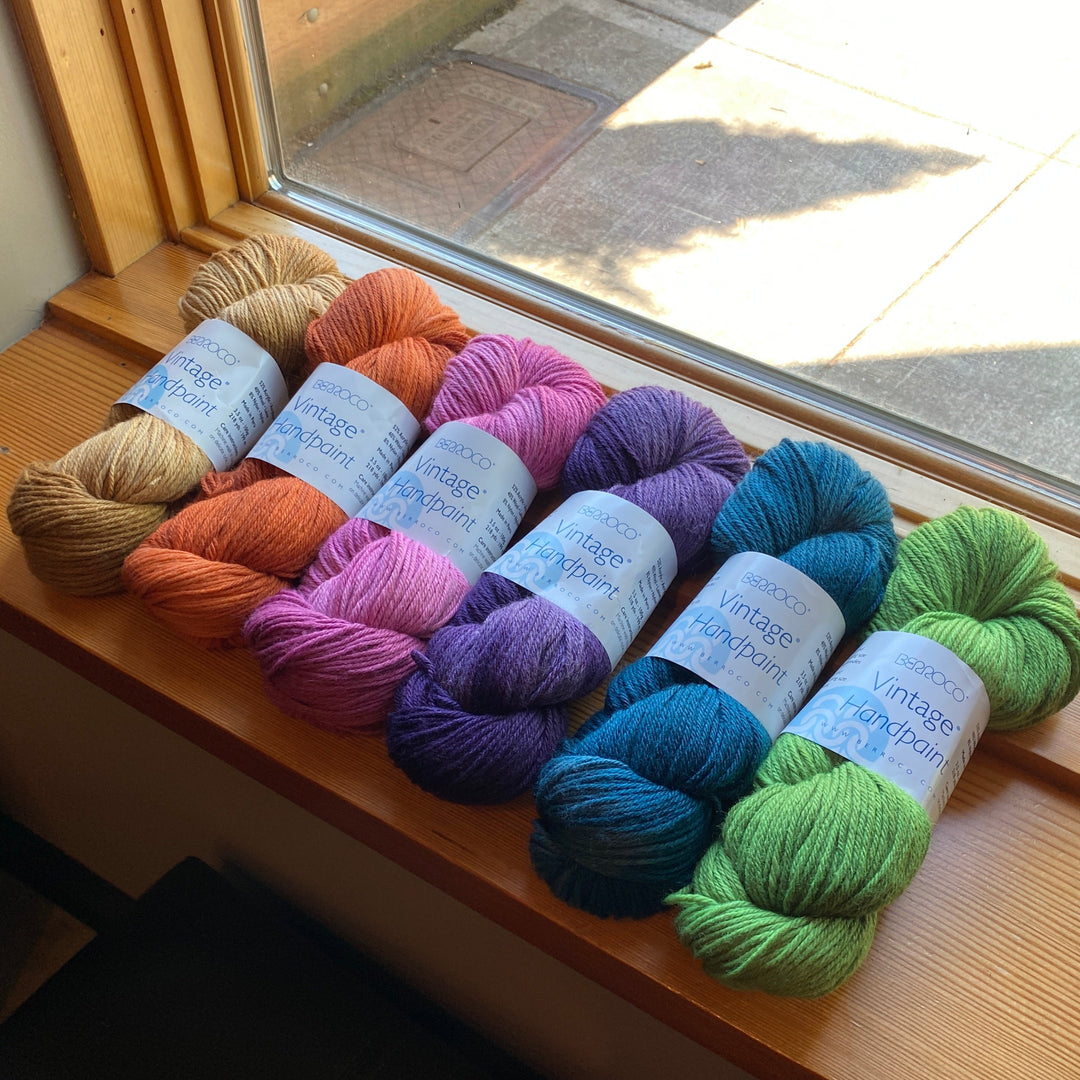 Assorted colorful yarn skeins of Vitnage Handpaint on a windowsill