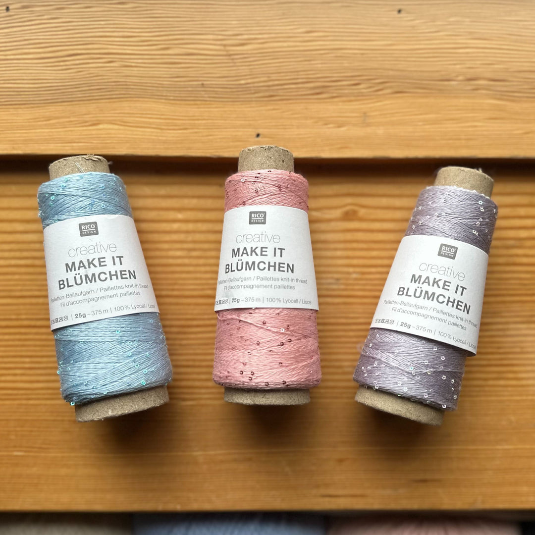 Three spools of yarn on a wooden surface with 'Make It Blumchen' label.