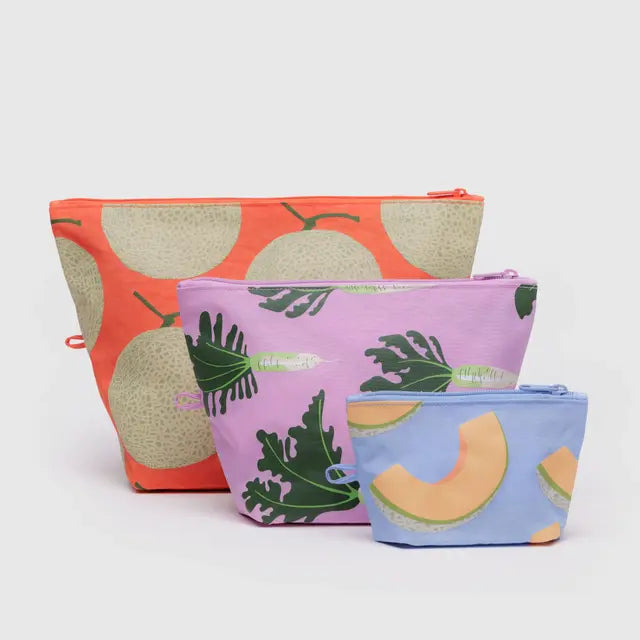 Three fabric pouches with fruit and leaf patterns on a white background