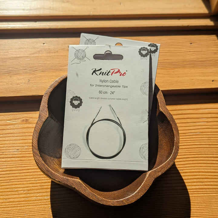 KnitPro cable packaging on a wooden surface