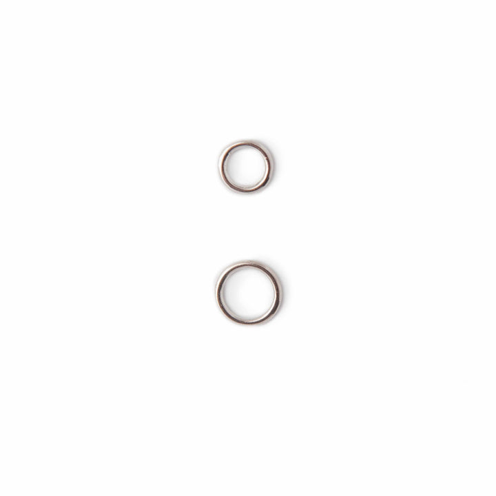 Two small metal rings on a white background